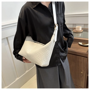 Detail of white woven PU leather crescent hobo bag with adjustable gold buckle strap
