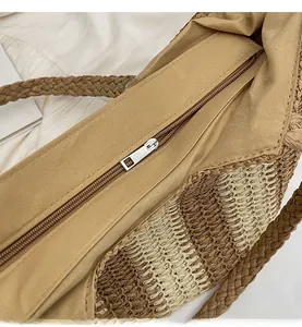 Detail of metal zipper closure and smooth fabric lining on beige woven tote bag
