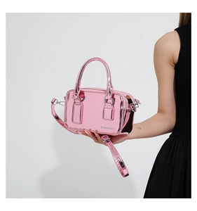 Detail view of pink metallic PU leather crossbody bag with glossy finish and handles