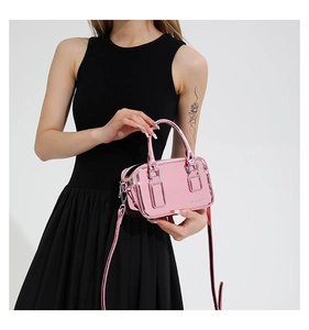 Close-up of pink metallic mirror PU leather crossbody bag with cylindrical handles