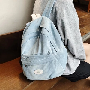 Stylish light blue denim backpack with Musiluo logo patch for a trendy casual look