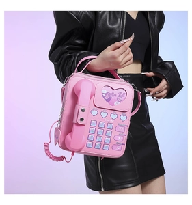 Close-up of pink PU leather handbag featuring vintage telephone design with handset detail