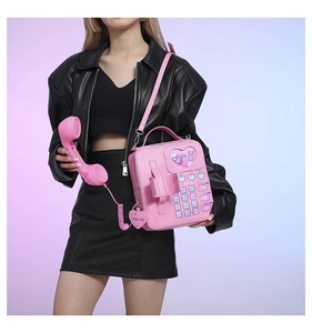 Detail of pink vintage telephone shaped PU leather crossbody bag with Y2K dial design