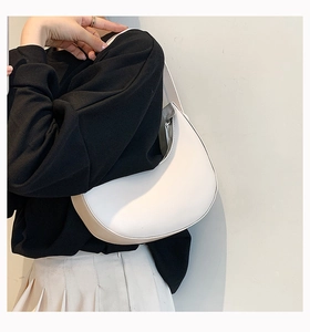 Minimalist white half-moon PU leather shoulder bag shown on a model for daily styling