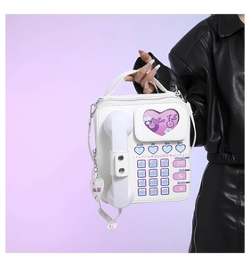 Detail view of white PU retro telephone bag with pink dial and heart-shaped accents