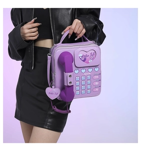 Detail of vintage purple telephone shaped PU leather crossbody bag with heart dial design