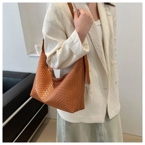 Close-up of brown woven PU leather hobo bag with adjustable shoulder strap detail