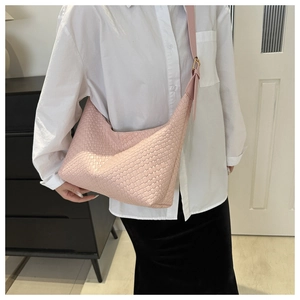 Pink woven PU leather half-moon shoulder bag styled with white shirt and black skirt