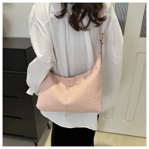 Pink woven PU leather hobo bag worn over the shoulder showing the large capacity and style
