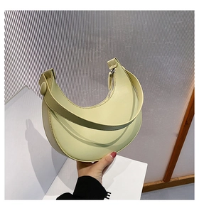 Detail view of the sleek PU leather texture and zip closure on the crescent shoulder bag