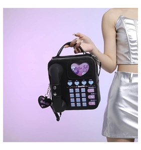 Detail of retro telephone shaped PU crossbody bag with mailbox full heart window