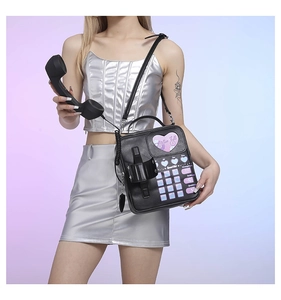 Detail of vintage telephone-shaped PU leather crossbody bag with pink heart and dial pad