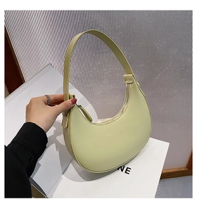 Detail of light green crescent shoulder bag made of high-quality smooth PU leather