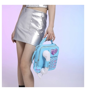 Detail of light blue PU leather handbag in retro telephone shape with heart window