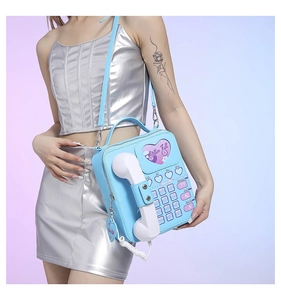 Detail of light blue vintage telephone bag with heart keypad and handset accessory