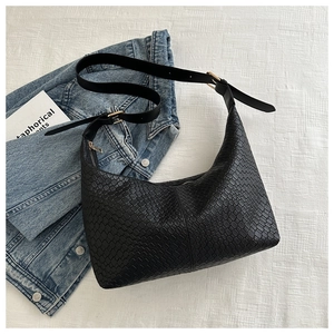 Minimalist black embossed PU leather underarm bag with adjustable strap and gold hardware