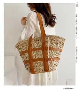 Straw tote bag detail showing beige woven texture, tan leather straps, and drawstring closure