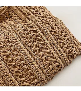 Macro detail of natural straw woven texture with premium faux leather stitching trim