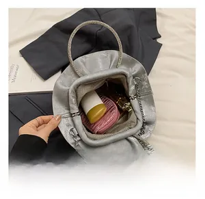 Top view of open cloud evening bag showing spacious interior with pink cosmetic pouch