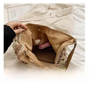 Macro shot of straw tote interior featuring brown fabric lining and inner side pocket