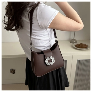 Detail showing elegant coffee brown PU leather shoulder bag with sparkling crystal buckle