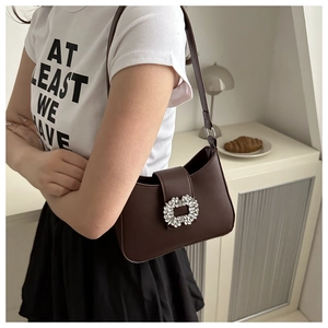 Detailed view of dark brown PU leather shoulder bag featuring a sparkling crystal buckle