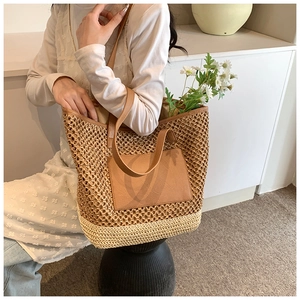 Chic woven straw tote bag in brown and cream bicolor design with leather shoulder straps