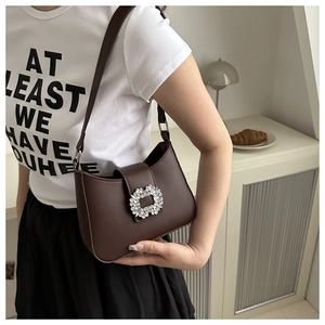 Close-up of a brown PU leather shoulder bag with a square rhinestone buckle detail