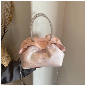 Detail of pink floral jacquard fabric bag with rhinestone round handle and chain strap