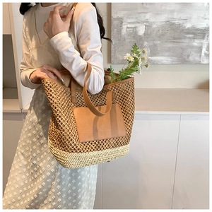 Detailed texture of straw woven tote bag with brown PU leather strap for summer style