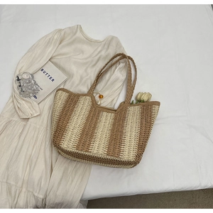 Minimalist striped woven straw tote bag for women in beige and tan on a neutral background
