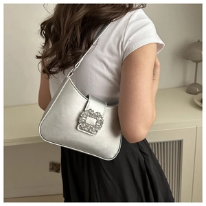 Detailed close-up of a silver PU leather handbag with a sparkling rhinestone buckle decoration