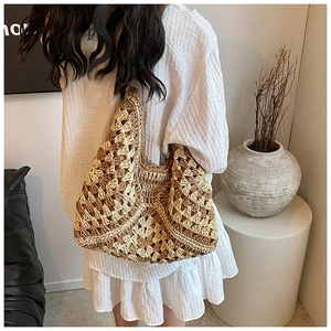 Detail of bohemian hollow crochet straw tote bag showing natural texture and V-shaped design
