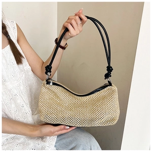 Detailed macro view of woven straw texture and black leather strap with knot detail