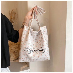 Detail of floral canvas tote bag with My Sunday print shown in a lifestyle setting