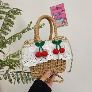 Handmade woven straw tote bag with white lace trim and red crochet cherries design