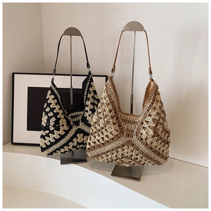 Detail of hand-crocheted hobo tote bags in geometric black and brown woven patterns