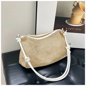 Chic woven straw crossbody bag with white rope handles and zipper closure on black base