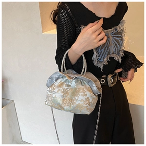 Detailed view of embroidery pattern and diamond ring handle on the PU fabric crossbody bag