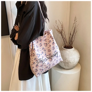 Detail view of floral canvas tote bag with My Sunday text and long shoulder straps