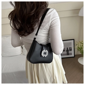 Detailed view of black PU leather half-moon shoulder bag with sparkling square diamond buckle