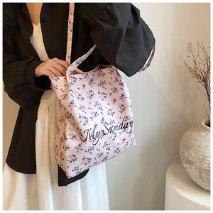 Close-up of pink floral tote bag with My Sunday text print on high-quality fabric