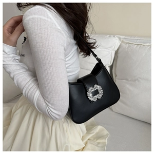 Close-up of black PU leather shoulder bag with a large crystal-encrusted rectangle buckle