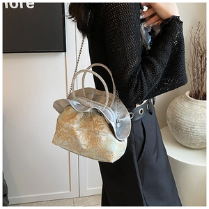 Detailed view of PU crossbody bag with golden tree embroidery and rhinestone handles