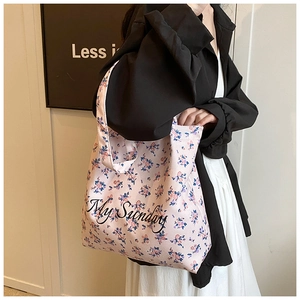 Detail view of floral canvas tote bag with My Sunday print on shoulder strap