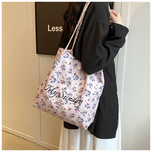 Detailed view of pink floral canvas tote bag featuring black My Sunday script lettering