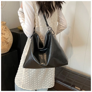 Hobo style black PU leather shoulder bag with glossy texture and silver chain strap