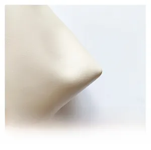 Close-up of premium lychee pattern leather material on a minimalist bucket bag