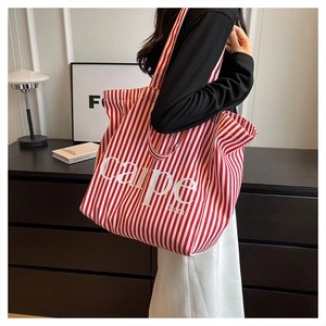 Red and white striped canvas tote bag featuring carpe diem print with wide shoulder strap