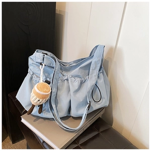 Fashionable light blue pleated cloud crossbody bag with cute plush latte charm and strap